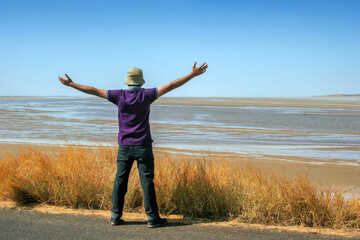 Winning, success , and life goals concept. Young man with arms in the air giving thumbs up.