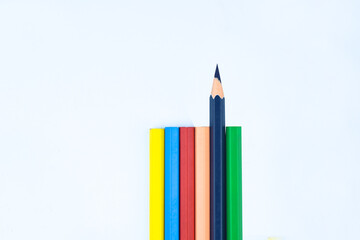 Six different colored wood pencil crayon while one facing different way