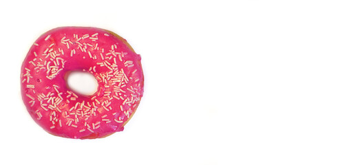Appetizing donut in a pink glaze with white sprinkle isolated on a white background. Unhealthy nutrition, sugar addiction concept. Close up. Website header, banner. Copy space, horizontal arrangement.