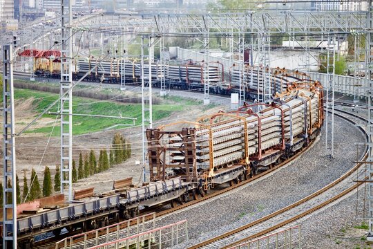 Freight train transports railway elements. Modern railways infrastructure construction. Railway transportation. railway crane at work. freight train. cargo transportation in the city. Railroad track. 