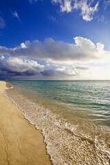 Ocean coastline. Relaxing holiday on a sandy beach. Indian ocean islands. Sunny day on Mauritius island. Sea sand and Sun. Calm ocean and clear blue sky. Idillic Scenic tranquil landscape. Zen-like.