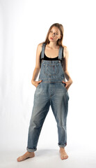 young girl in denim overalls, studio shooting
