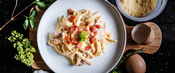 Pasta Carbonara in white dish, with fresh ingredient
