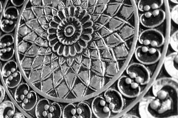 black and white closeup on a floral pattern metalwork retro art piece