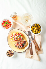 Delicious bruschettas with mushrooms, blue cheese, olives and tomatoes