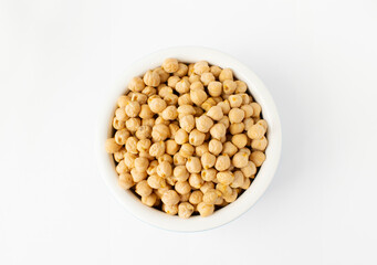 Chickpeas in a handmade ceramic bowl on grey background. Garbanzo beans traditional Near Easten food. Top view.