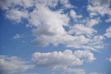 Naklejka na ściany i meble Blue sky on a sunny day with fluffy white clouds. Nature background.