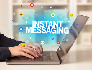 Freelance woman using laptop with INSTANT MESSAGING inscription, Social media concept