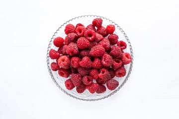 Raspberries on a plate white background 