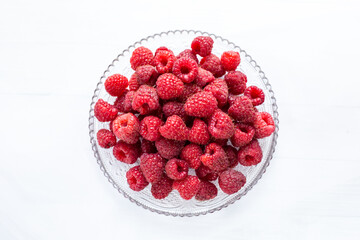 Raspberries on a plate white background 