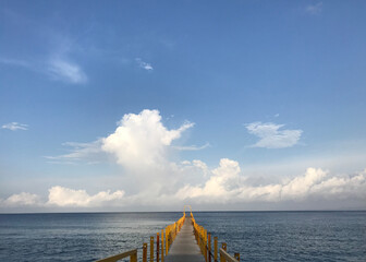 yellow bridge stretching into the distance in the ocean