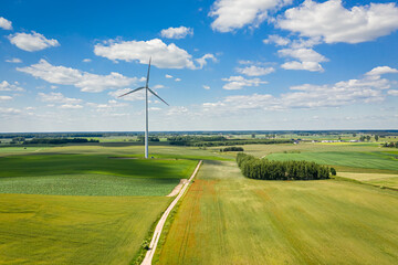 Green field and wind turbines in summer day, Poland