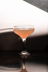 cocktail coupe with red pink drink on white background