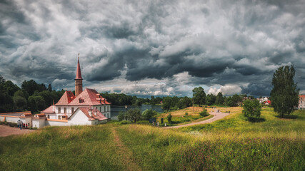 Fototapeta na wymiar Panoramic summer cloudy landscape with a Priory Palace in Gatchina. Russia