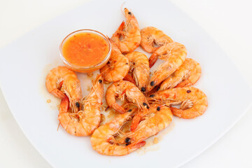 Shrimps with sauce on the white plate. From above