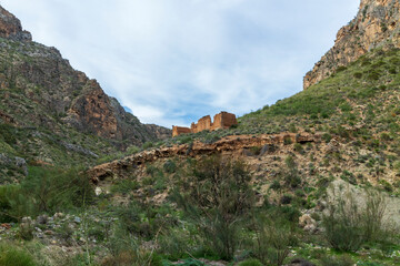 small ruined construction on the side of a mountain