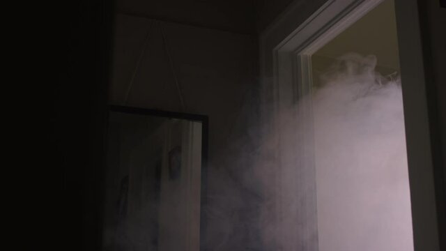 White smoke starts to billow from a bedroom doorway when a house fire starts