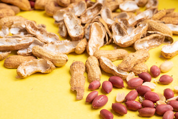 Dried peanuts on the yellow paper, copy space