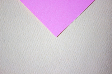 Abstract background of minimalism texture of colored paper. Pink triangle on a yellow background. Minimal geometric shapes and lines in pastel colors.