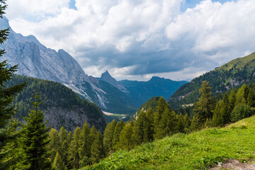 Fototapeta na wymiar Cloudy weather in Dolomites with view on evergreen forests