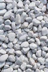Small white stones on the ground on a close up shot