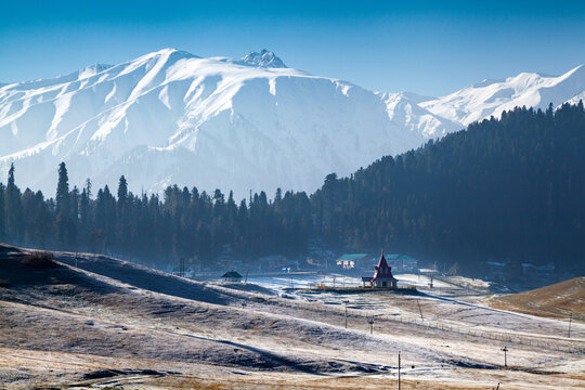 Long distance view of Lord Shiva temple with Snow Covered Himala