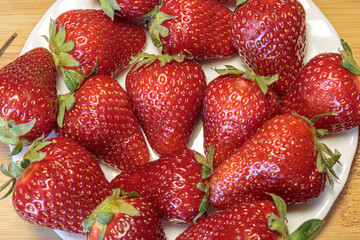 Fresh strawberry from berry farm in the bowl closeup. Concept of a vegan breakfast.