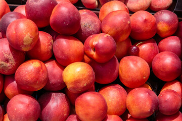 Ripe delicious juicy plums on the counter of a street market.