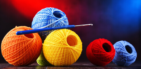 Assortment of different colored yarns and hook for crocheting