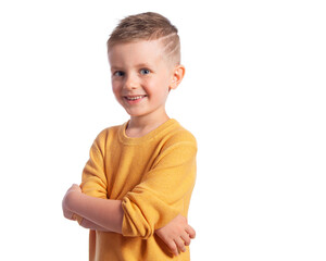 Portrait of a cute 6-year-old boy on a white background, side view. A beautiful and happy European child.