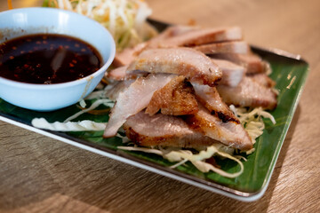Charcoal-boiled pork neck served with sauce is spicy sour taste