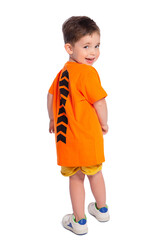 Portrait of a beautiful European boy 2 years old in full growth, rear view. A beautiful and happy child. A child's smile. Isolated on a white background in an orange t-shirt.