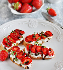 Sandwich with strawberries. With soft cheese and balsamic vinegar. Soft focus.
