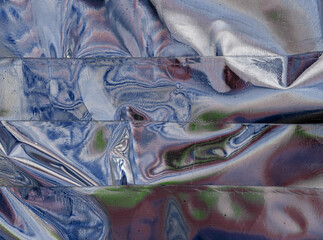 Holographic iridescent surface wrinkled foil pastel. Real Hologram Background of wrinkled abstract foil 80s texture with multiple colors. 90s aqua menthe pastel holographic gradient mesh template