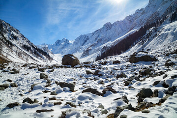 Fototapeta na wymiar Stone boulders appears as snow disappears at Himalayan Mountains