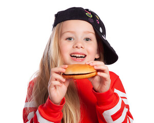 Beautiful European blonde girl in a baseball cap and a hamburger in her hands on a white background. Fast food, harmful and delicious food.