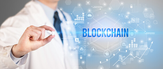 Doctor giving a pill with BLOCKCHAIN inscription, new technology solution concept