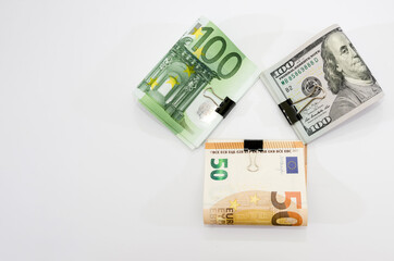Euro and dollars with a clip on a white background. Financial concept. Savings concept. Copy of space.
