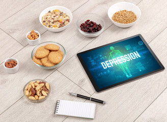 DEPRESSION concept in tablet with fruits, top view