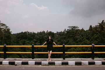 woman in dress on a bridge in Asia