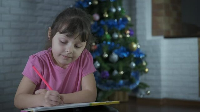 Child with a picture for santa.