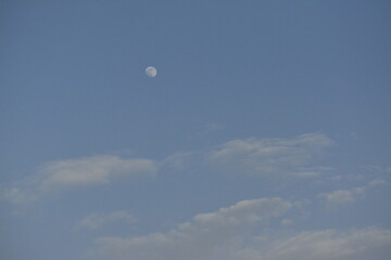 Moon and cloud on blue sky.