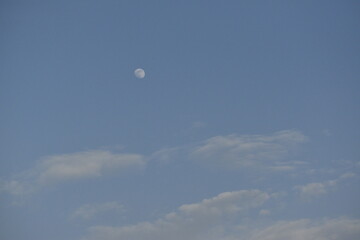 Moon and cloud on blue sky.