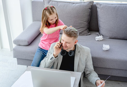 Girl Making Hairstyle To Teleworking Man