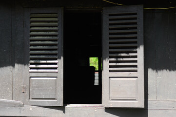 WEST SUMATERA, INDONESIA -JUNE 8, 2014: Traditional timber window at Tuo Kayu Jao Mosque in West Sumatra, Indonesia. Built in 1599 and is the second oldest mosque in Indonesia.