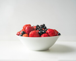 currant and strawberry in the plate, fresh berries