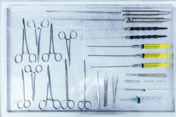 Surgical instruments set on desk. tools including scalpels, forc