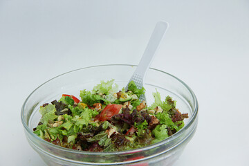 summer salad with fresh vegetables in a large glass plate