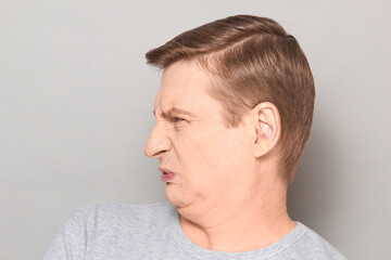 Obraz premium Portrait of funny man grimacing from disgust and squeamishness