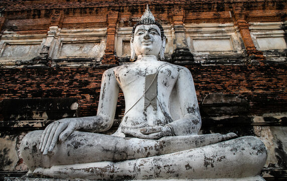 single Buddha statue inside Wat Yai Chai Mongkhon, a Buddhist temple of archaeological park, Ayutthaya, Thailand